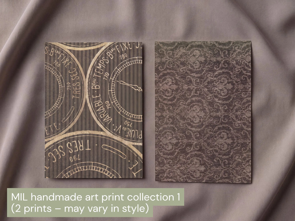 Two rectangular art prints displayed on draped taupe fabric. The left print features a vintage clock dial pattern in beige on a dark gray striped background, and the right print shows an ornate damask pattern in a muted olive-brown.