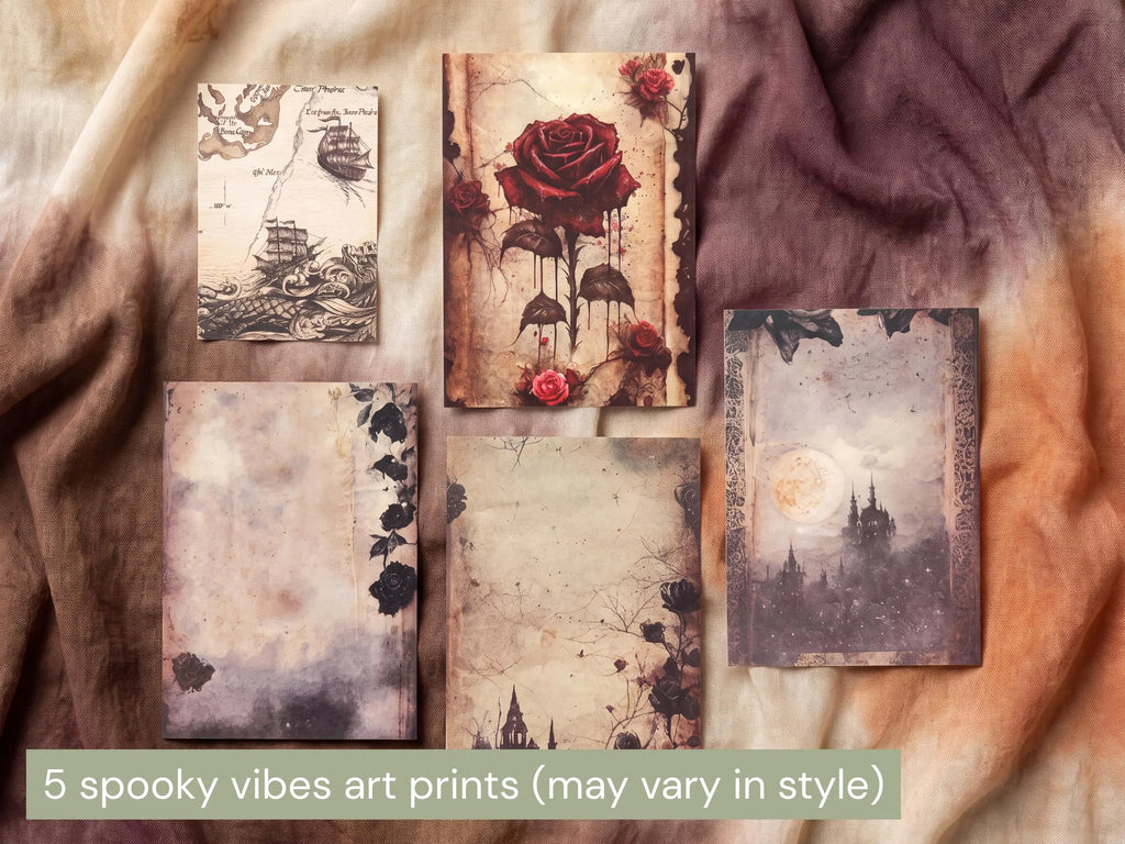 Five vintage-style art prints with gothic and spooky themes are arranged on a draped fabric background. The prints feature designs such as a rose with mushrooms, a sailing ship, a moonlit castle, and distressed floral borders.