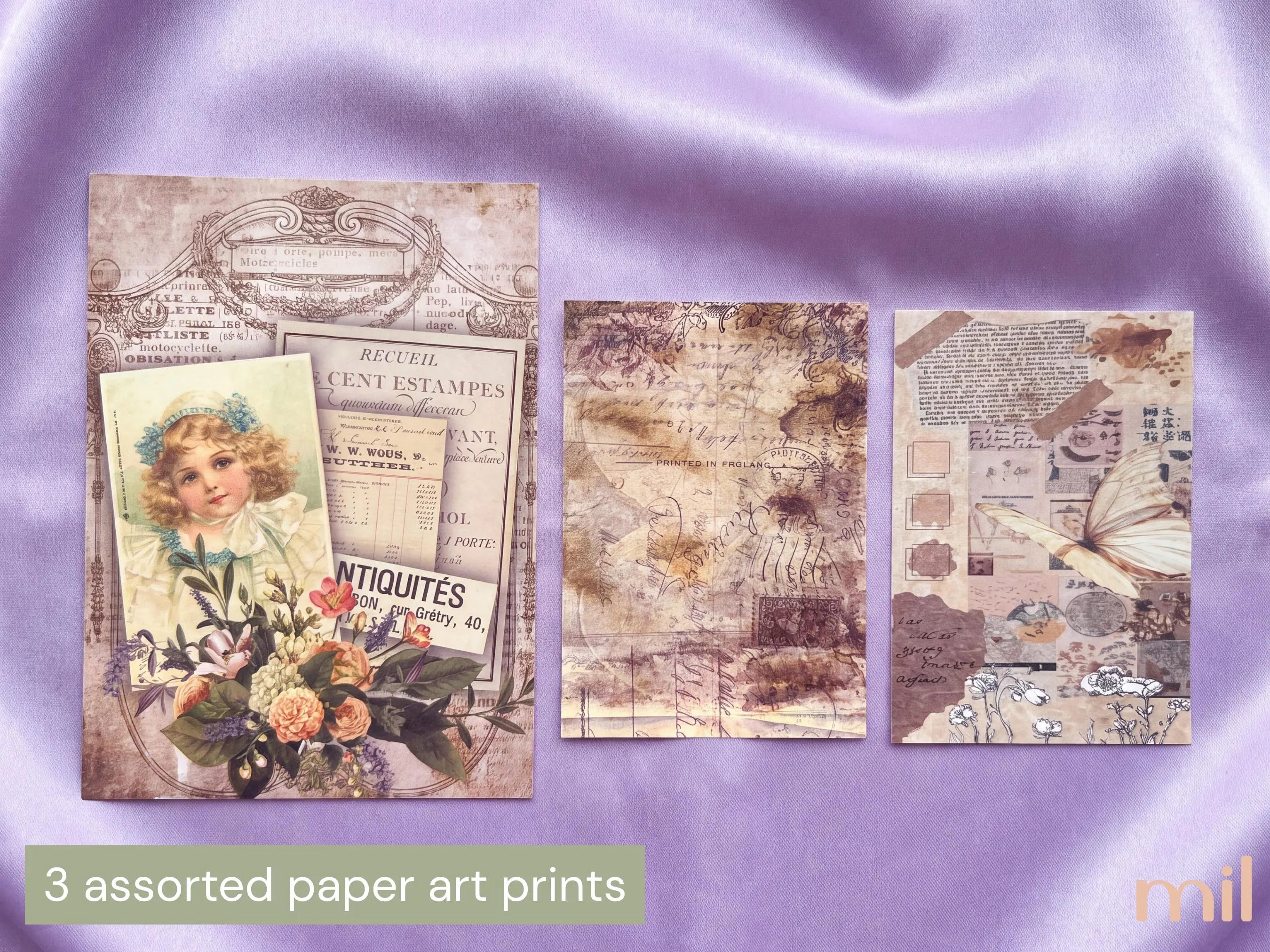 Three vintage-style paper art prints displayed on a lavender satin background, with a text label at the bottom reading '3 assorted paper art prints' 