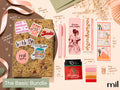 A styled flat-lay of a bookish-themed stationery bundle labeled 'The Basic Bundle,' blind date with a book featuring a kraft-paper book covered with stickers, a pink highlighter, a pink bookmark, floral bookmark strips, sticky notes, a tea bag, and other matching accessories on a beige background with ribbon and dried flowers.