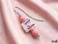 A pink and silver beaded bookmark with a decorative silver wire loop and a central printed card that reads 'Sorry I can't I have a Date with my Book Boyfriend,' displayed on a draped pink satin fabric background.