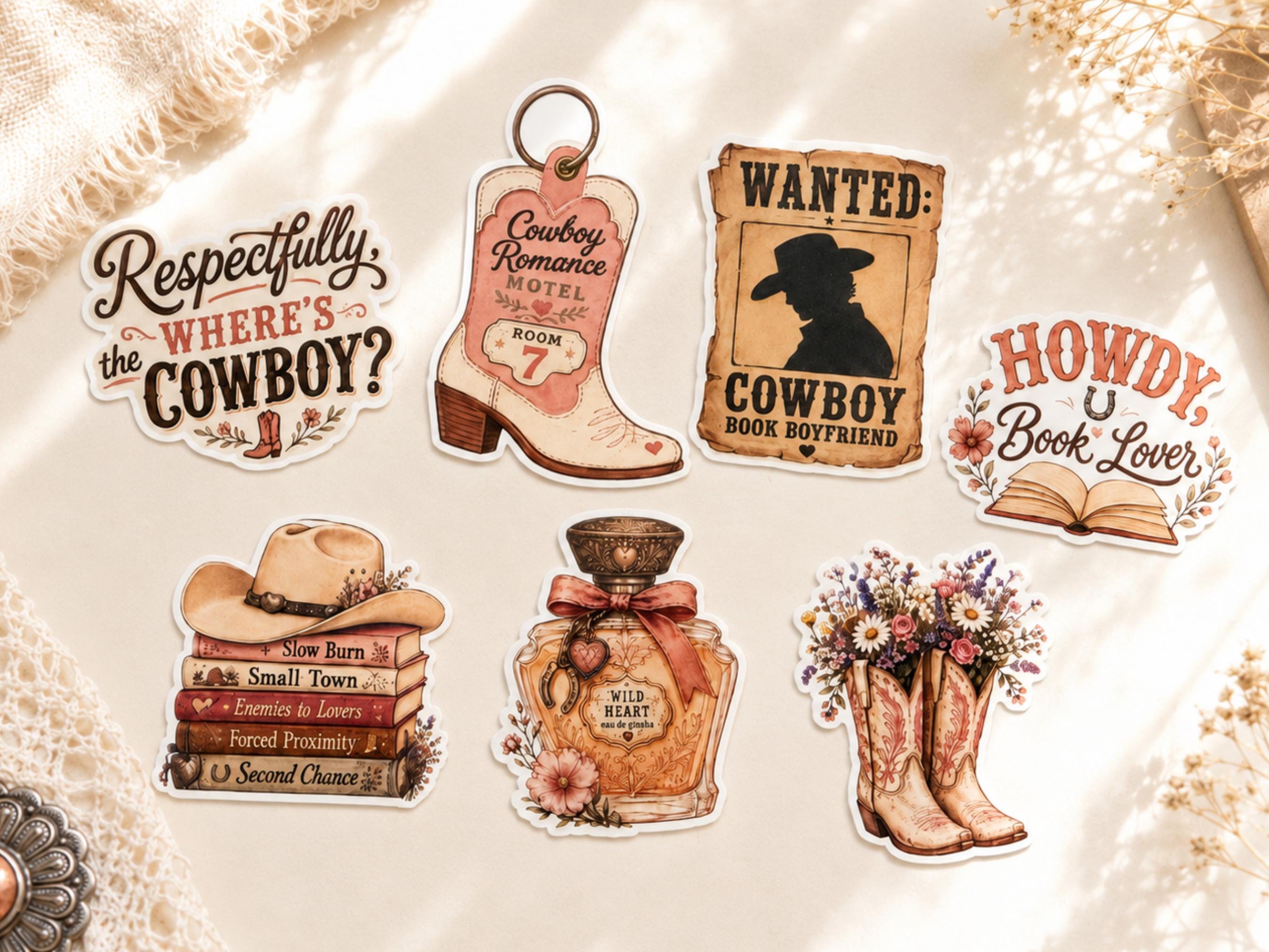 Six western-themed die-cut stickers arranged on a cream textured fabric background. The designs include a cowboy question mark, a cowboy boot with 'Cowboy Romance Hotel' text, a wanted poster for a cowboy book boyfriend, a 'Howdy, Book Lover' open book, a stack of books with a cowboy hat, and a perfume bottle labeled 'The Heart' with floral cowboy boots.