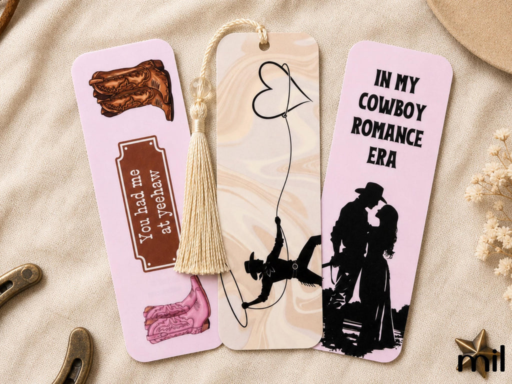 Three decorative bookmark tags with western-themed illustrations and text, arranged on a beige fabric background with small props.