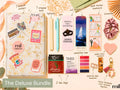 A collage-style promotional layout for a bundle titled 'The Deluxe Bundle,' showing multiple stationery and small accessory items arranged on a warm beige background with decorative illustrations and handwritten labels. Visible items include a decorated notebook or journal, a wrapped book, a pen, bookmark cards, highlighter paper, annotation tabs, tea bags, a leather heart bookmark, a bookmarks card, a scrunchie, and a keychain.