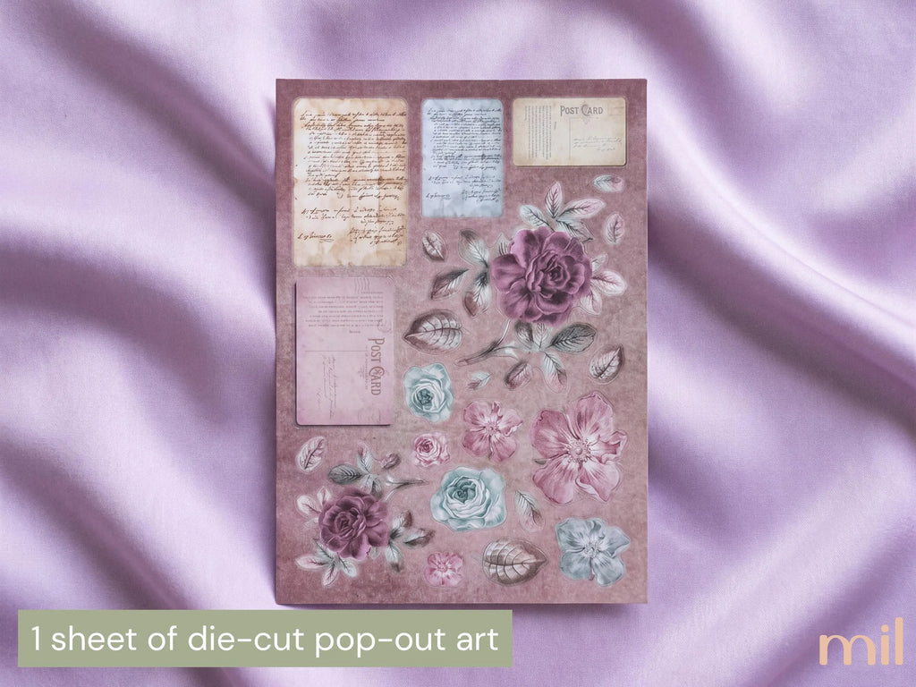 A sheet of vintage-style pop-out art stickers or craft cutouts featuring floral illustrations and aged paper inserts, displayed on draped lavender satin fabric. Text at the bottom reads '1 sheet of die-cut pop-out art'.