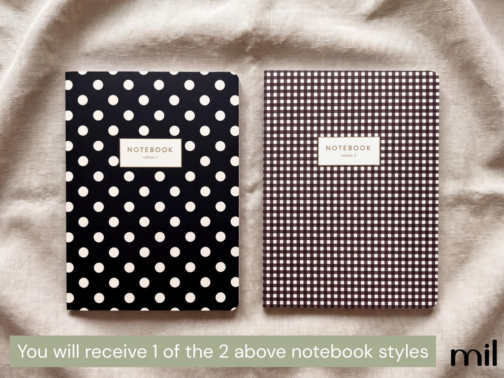Two notebooks displayed on a beige fabric background. The left notebook has a black cover with white polka dots and a white label reading 'NOTEBOOK'.
