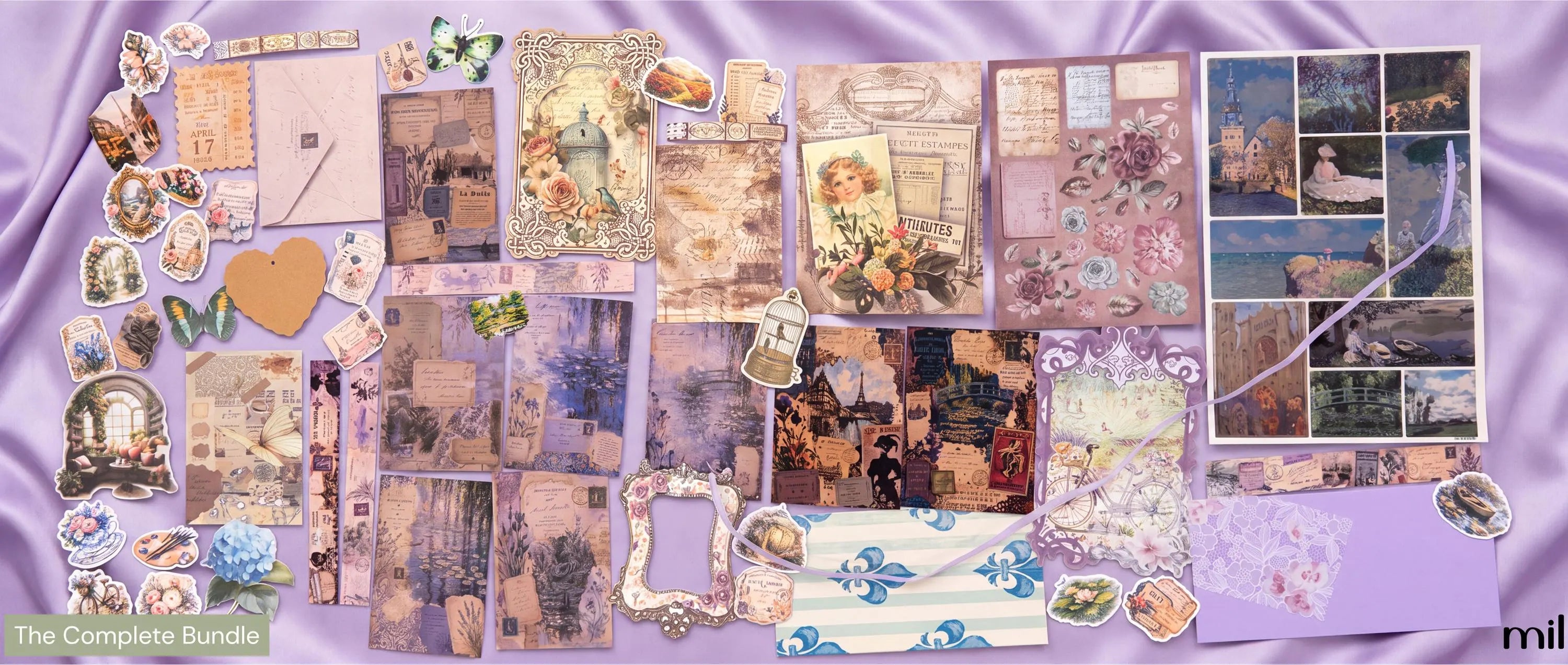 A flat-lay display of a scrapbook paper and embellishment bundle titled 'The Complete Bundle'. The collection features various vintage-style papers, floral designs, photo collages, stickers, and decorative elements arranged on a lavender satin fabric background.