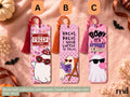 Three Halloween-themed bookmark sets with tassels are displayed on a textured pink fabric background. The bookmarks feature cute cartoon ghost illustrations with funny quotes: 'Let's CREEP IT REAL' on a red tassel, 'HOCUS POCUS I NEED COFFEE TO FOCUS' on an orange tassel, and 'BOO! IT'S SPOOKY SEASON' on a pink tassel.
