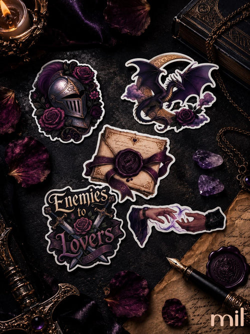 A set of five gothic-themed die-cut stickers displayed on a dark, moody flat-lay background with purple rose petals, a vintage book, a candle, and a fountain pen. The stickers feature a knight helmet with roses, a bat on a crescent moon with roses, a wax-sealed letter, the text 'Enemies to Lovers' with crossed swords and a rose, and a hand holding a glowing dagger.